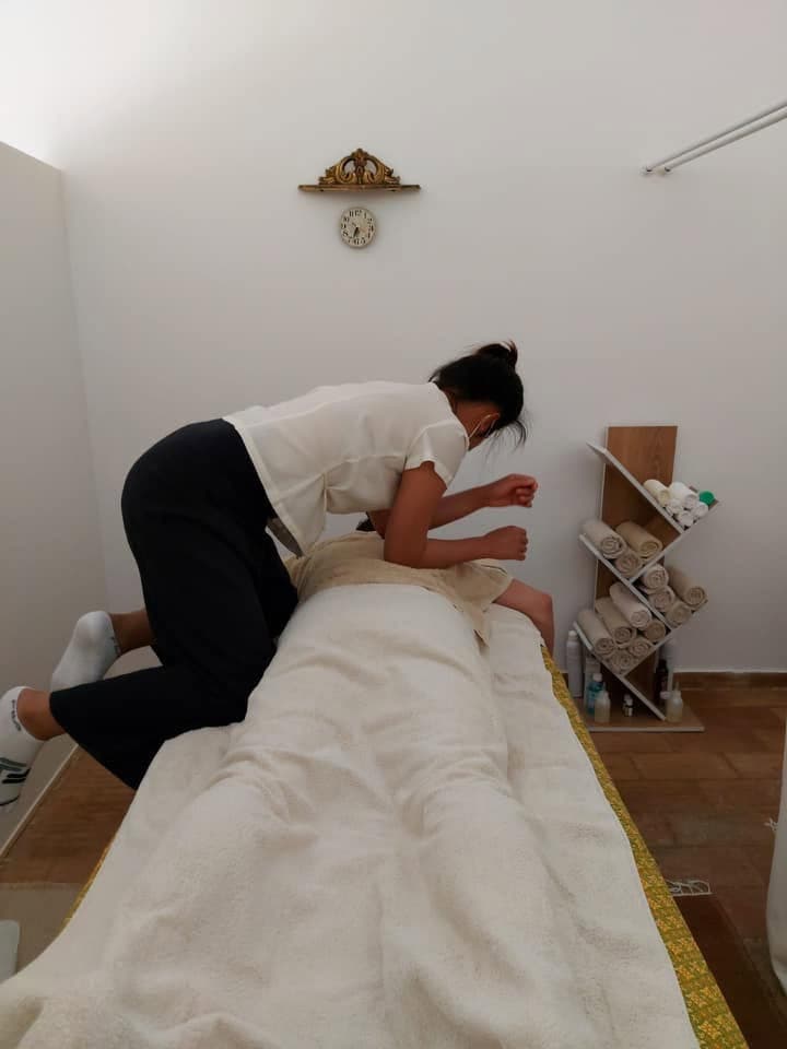 A therapist using focused hand pressure to work through tension in a guest's back