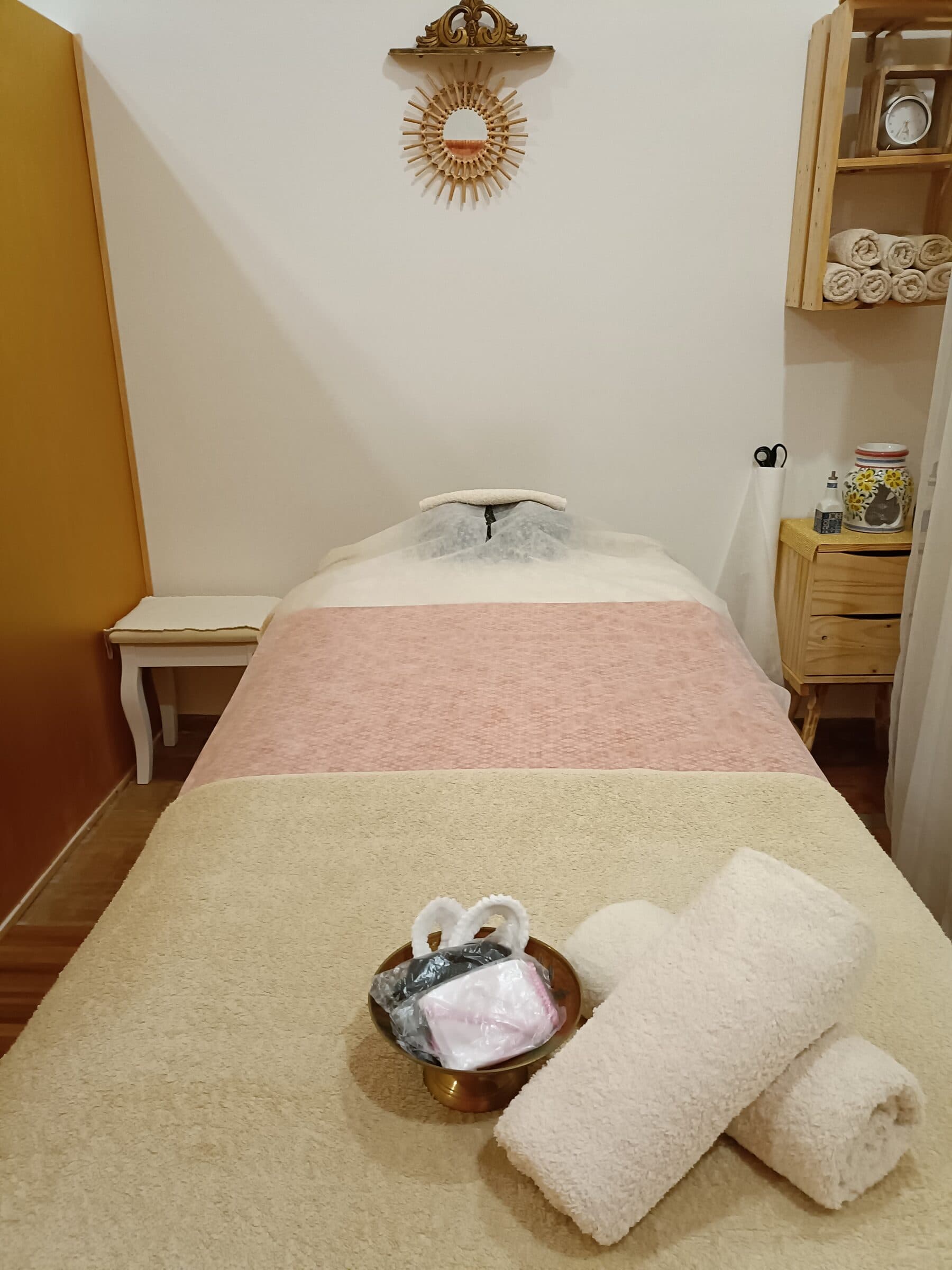 A treatment bed dressed with a bold orange curtain backdrop