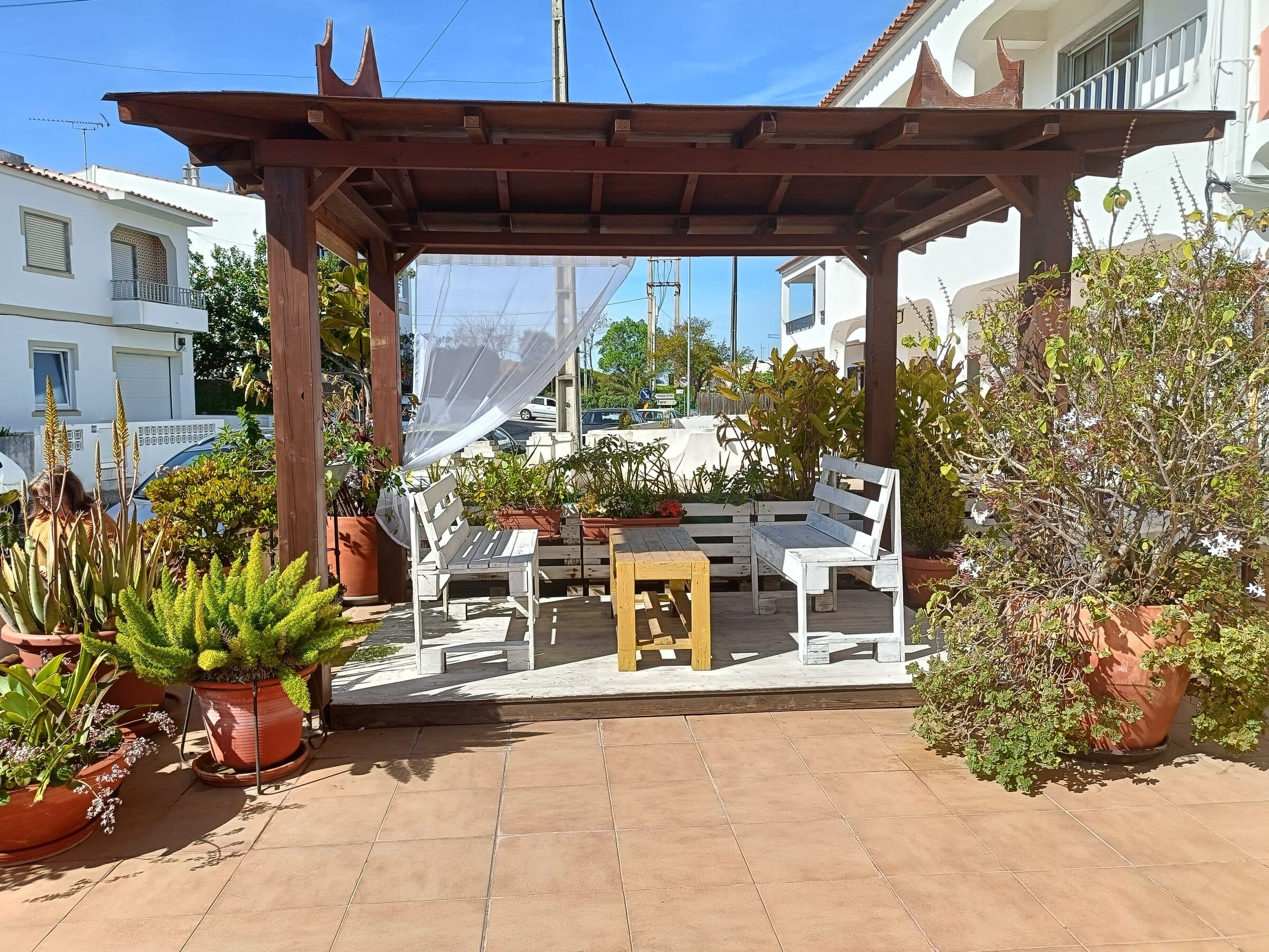 The garden patio with a pagoda-roofed pergola