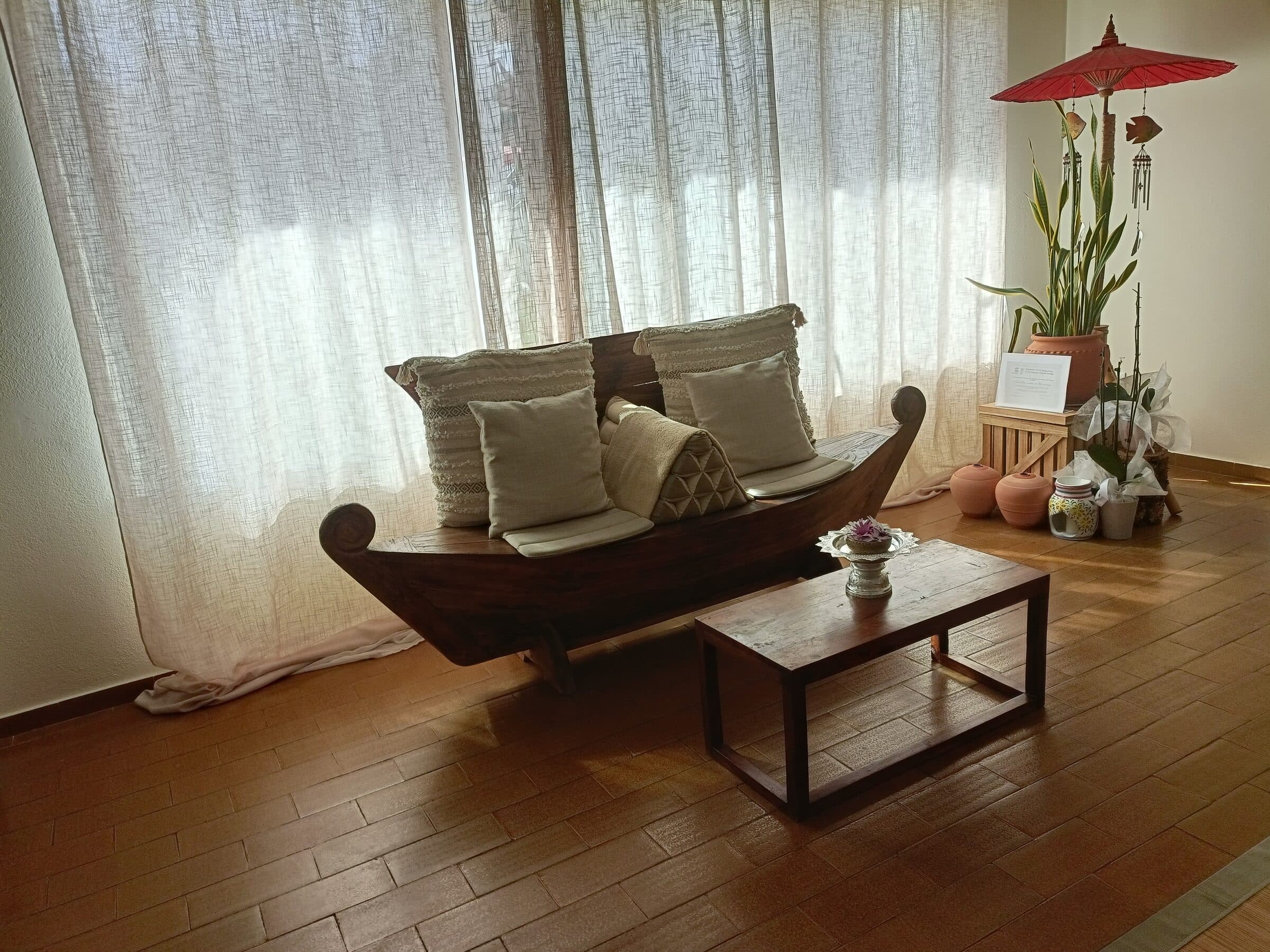 A carved wooden bench in the studio's lounge area