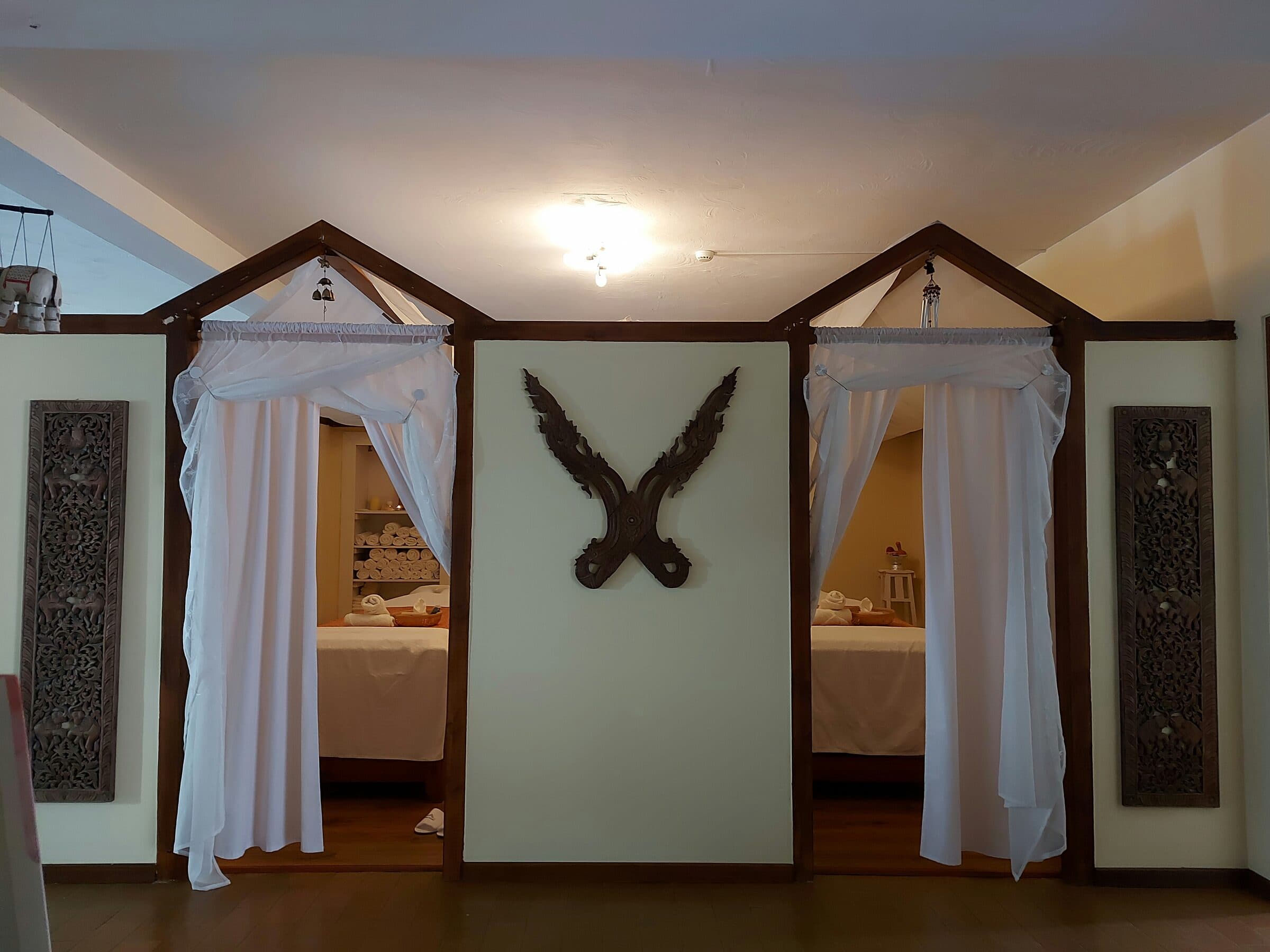 Twin treatment-room entrances framed by a carved wooden centrepiece