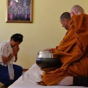 A monk performing a traditional blessing ritual